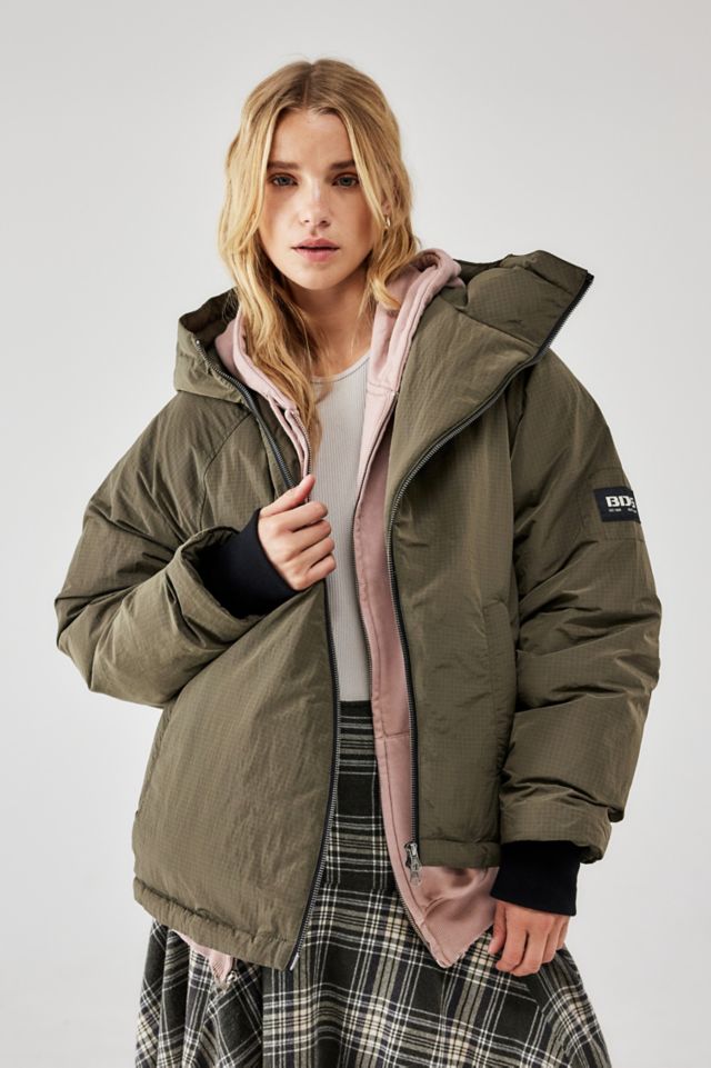 Asymmetric padded clearance coat