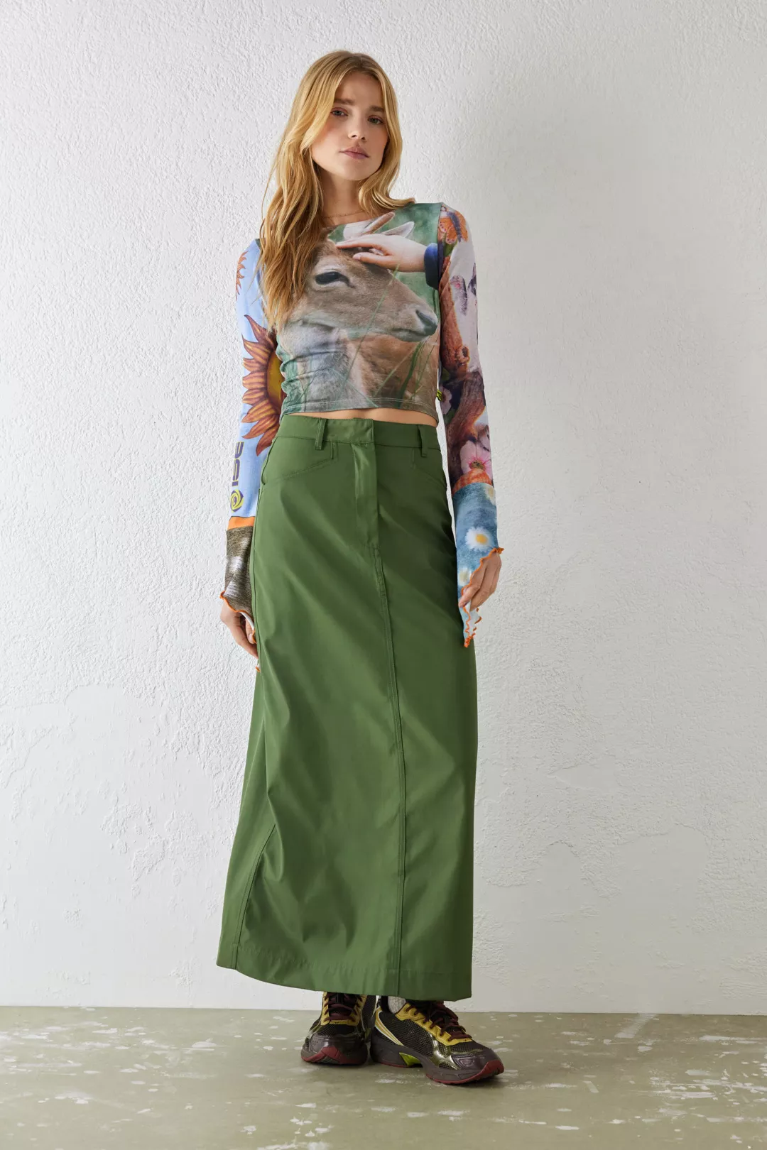 Urban Outfitters khaki green Utility-style cargo maxi skirt from Basic Pleasure Mode. Crafted from a nylon-inspired fabrication Ft. a midrise waist with a button fastening, belt loops, side pockets and a long maxi hem. Finished with two pockets to reverse and a split for added flexibility. Complete with logo detailing to reverse pockets.


