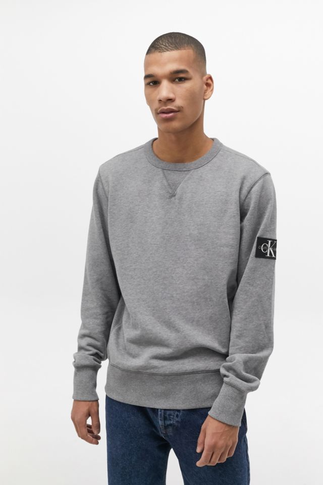 Calvin Klein Jeans Monogram Badge Logo Grey Sweatshirt | Urban Outfitters UK
