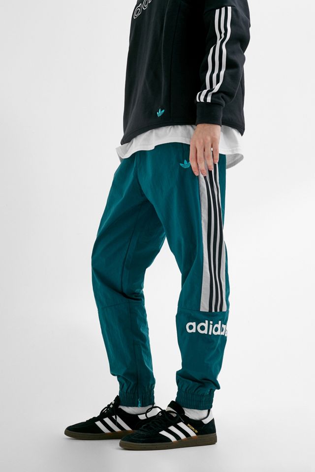 adidas – Gewebte Trainingshose „92“ in Blau mit Logos #1
