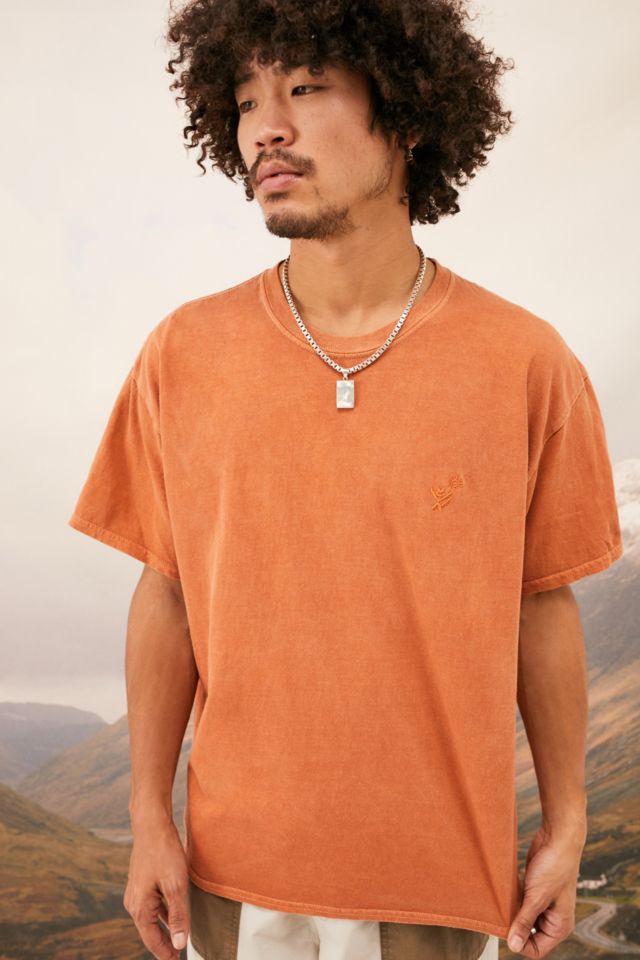 Nomad store orange shirt