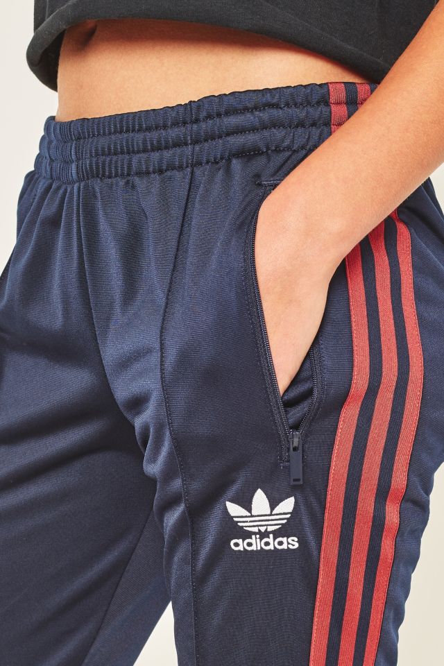 Blue track pants with best sale red stripe